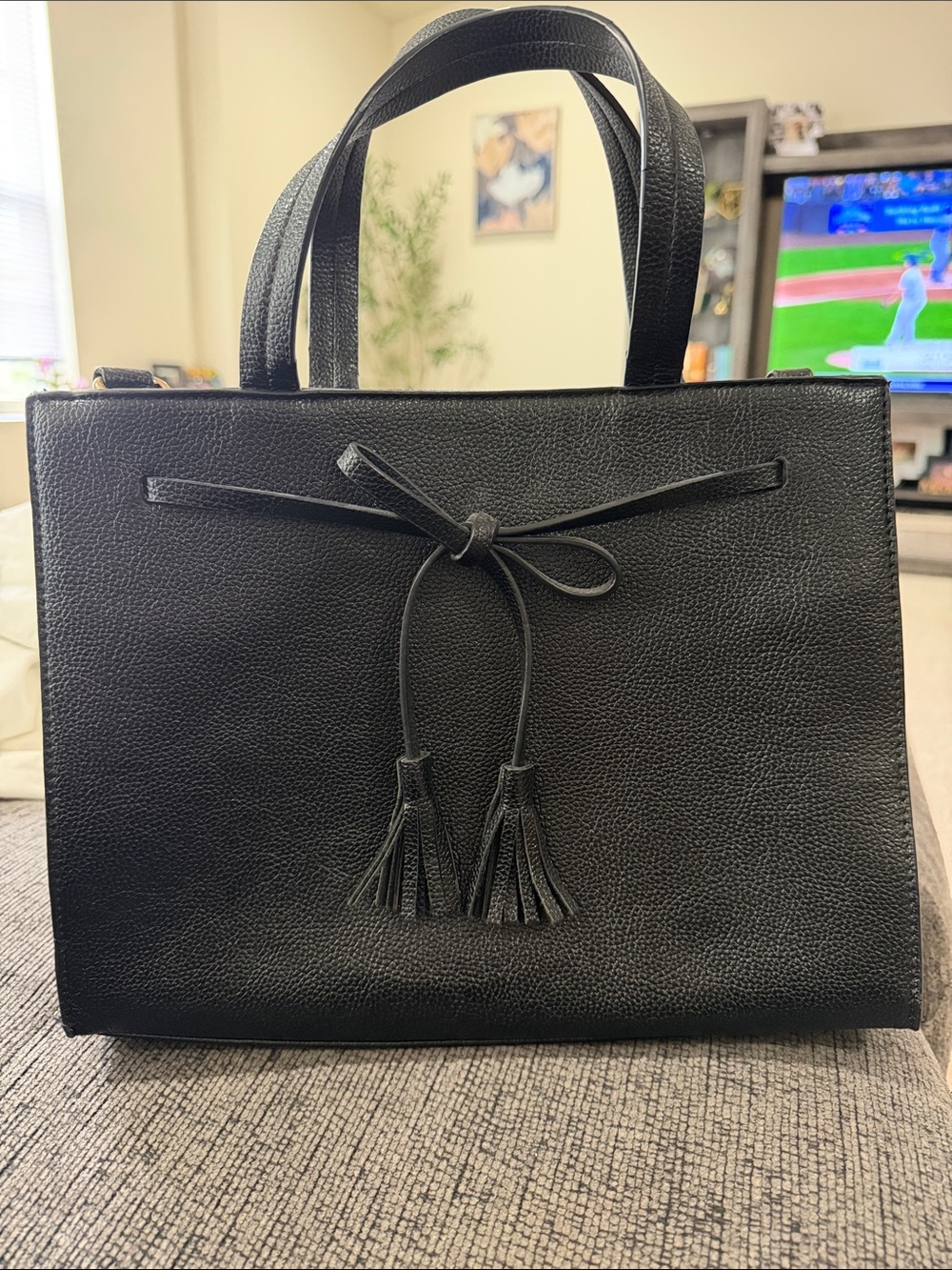 Classic Black Leather Tote Handbag with Tassel Accent